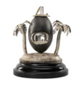 CRICKET CLUB HOUSE: NOVELTY AUSTRALIAN EMU EGG CRICKET TROPHY, mounted on white metal base with palm