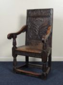 OAK JOINED WAINSCOT CHAIR, c. 1700, with a later carved central panel back, chip carved edge seat,