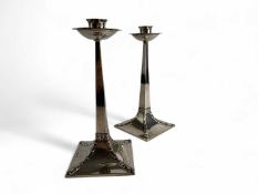 PAIR OF EDWARD VII ARTS & CRAFTS SILVER CANDLESTICKS, of tapered square design, spreading square
