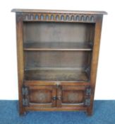 17TH CENTURY STYLE OAK BOOKCASE CUPBOARD, open section with a single shelf, over double cupboards