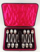 CASED SET OF TWELVE VICTORIAN SILVER TEA SPOONS & MATCHING SUGAR TONGS with Rococo form handles,