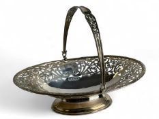 EDWARD VII OVAL SILVER SWING HANDLED BASKET with scroll pierced border, on oval foot, William