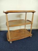 ERCOL ELM THREE TIER TEA TROLLEY, 71cm (w), 46cm (d), 75cm (h) Provenance: private collection