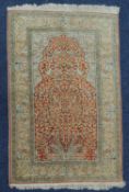 KASHAN SILK PRAYER RUG, late 20th Century, terracotta mihrab with birds amidst the branches of a