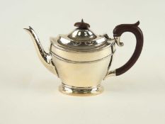 GEORGE V SILVER TEAPOT, maker H.M., Birmingham 1927, with bakelite handle and finial, 13.5cm (h),