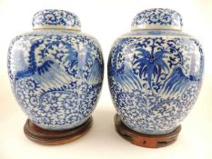PAIR OF CHINESE BLUE AND WHITE COVERED GINGER JARS, 19th Century, decorated with phoenix flying