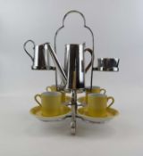 UNUSUAL 1930'S COFFEE SET, plated open frame holding four Carlton yellow glazed coffee cups and