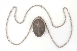SILVER OVAL PICTURE LOCKET, with engraved decoration, 40 x 30mm, with chain, 64cm (l) Provenance: