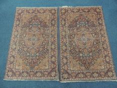 PAIR OF KASHAN WOOLLEN RUGS, c. 1900-20, having a deep blue field with central red and light blue