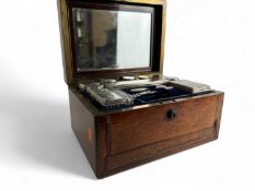 MID VICTORIAN ROSEWOOD VANITY BOX, circa 1855, fitted with a complement of silver topped bottles and