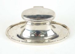 GEORGE V SILVER OVAL INKWELL, with hinged cover and glass liner, 14cm (w) Provenance: private