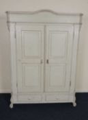 CONTINENTAL PAINTED PINE ARMOIRE, arched cornice over double panelled doors, base with two
