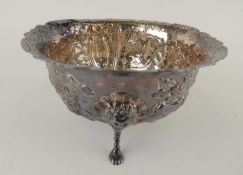 VICTORIAN CIRCULAR SILVER BOWL, repousse decoration of flowers and animals, raised on three lion's