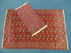 BOKHARA WOOLLEN RUG, terracotta ground, 253 x 168cms; also a PAKISTANI BOKHARA SMALL WOOLLEN RUG,