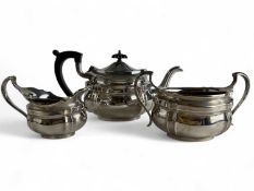 GEORGE V SILVER TEA SERVICE of oval shaped form, teapot with ebonised handle and finial, Blackmore &