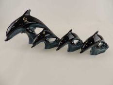 POOLE POTTERY DOLPHIN, 27.5cm, and THREE SMALLER POOLE DOLPHINS (4) Provenance: private collection