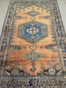 VEIS WOOL CARPET, orange and blue ground with centre medallion, floral border, 332 x 220cms