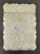 VICTORIAN SILVER CARD CASE, of shaped rectangular form, profusely engraved with scrolls and vacant