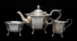 GEORGE V SILVER THREE PIECE TEA SERVICE, London 1929, hexagonal section on hoof feet, teapot