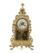 EARLY 20TH C. FRENCH BRASS MANTEL CLOCK, of Rococo form, with Roman dial, back plate stamped 'H & F,