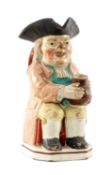19TH CENTURY POTTERY TOBY JUG, seated character with frothing jug of ale, very long stem clay