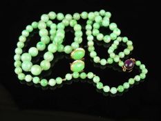 JADEITE BEADED HARDSTONE NECKLACE with 9ct gold amethyst cabochon clasp, 51cms (l); also a pair of
