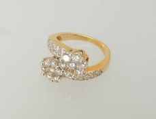 DIAMOND CLUSTER CROSSOVER RING, with two flowerhead clusters of small pavé set brilliants, with