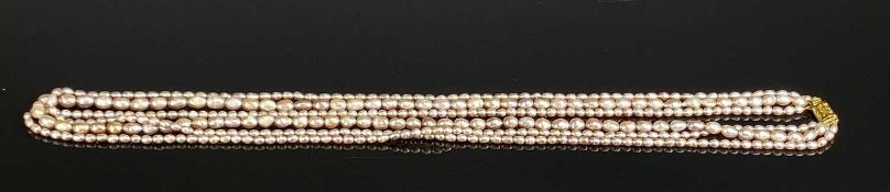 NATURAL PEARL THREE-STRAND NECKLACE, with yellow metal clasp, 80cms (l) Provenance: private