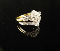 18CT WHITE & YELLOW GOLD DIAMOND CLUSTER RING, centred with a flower head cluster of seven