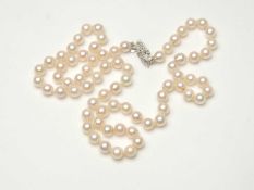 CULTURED PEARL NECKLACE, with uniform 6mm diameter pearls united by a 9ct white gold clasp set