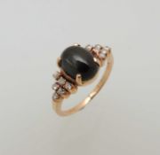 14CT GOLD CABOCHON GEMSTONE & DIAMOND CLUSTER RING, central stone approx. 9 x 6mms, bordered with