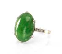 JADE & DIAMOND RING, oval cabochon jade stone 14 x 10mm, with 6 small diamonds at the shoulder,