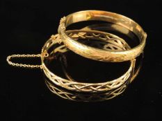 TWO 9CT GOLD BANGLES, one being of open Celtic design, cuff size 59mms (diam.), 12.6g; the other