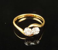 DIAMOND TWO-STONE CROSSOVER RING, set with two old round-cut diamonds, totalling approx. 0.5ct,
