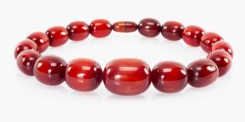 STYLISH CHERRY 'AMBER' BEAD NECKLACE, the toned oval bead from 39 to 27mms (diam.) Provenance: