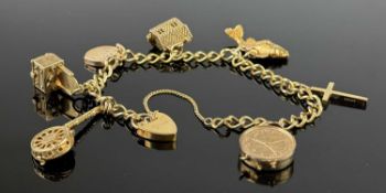 9CT GOLD CURB LINK CHARM BRACELET with padlock clasp and safety chain, seven hallmarked charms,