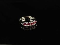 18CT WHITE GOLD RUBY & DIAMOND CLUSTER RING, set with four oval-cut rubies dispersed with tiny