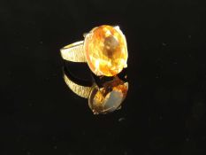CITRINE (UNTESTED) DRESS RING in unmarked yellow gold, testing as 18ct, oval-cut stone approx. 16