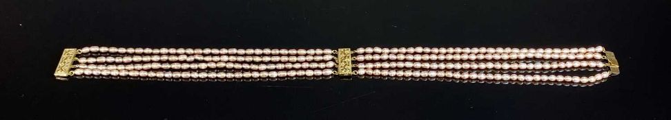 FRESHWATER PEARL CHOKER, with ornate pierced yellow metal clasps, 36cms (l) Provenance: private