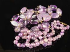 TWO AMETHYST HARDSTONE NECKLACES, including a circular beaded necklace with 9ct gold clasp, 64cms (