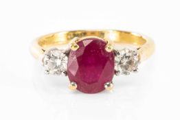 RUBY & DIAMOND THREE STONE RING, central oval cut ruby 8 x 7mm, diamond total weight 0.4cts, to 18ct
