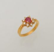 18CT GOLD RUBY & DIAMOND FLOWERHEAD CLUSTER RING, centred with an oval-cut ruby approx. 0.25cts,