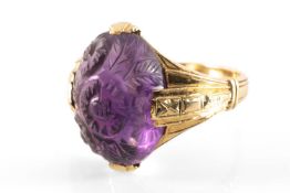 AMERICAN 14CT GOLD CARVED AMETHYST RING, by Joseph Jessop, the oval cabochon stone carved with