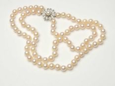 CULTURED PEARL TWO STRAND CHOKER NECKLACE, with uniform 7mm diameter pearls united by an 18ct