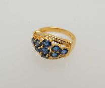 18CT GOLD SAPPHIRE & DIAMOND CLUSTER RING, nine small oval-cut sapphires, bordered with tiny