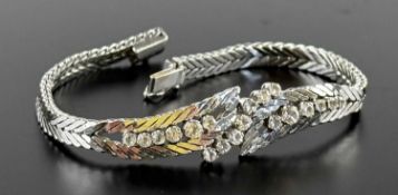 18CT WHITE GOLD BRACELET, set with round-cut white sapphires in cross-over leaf form and herringbone