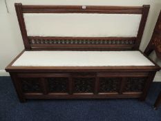 VICTORIAN CARVED PROBABLY CAMPHORWOOD AND UPHOLSTERED BOX SETTLE, stamped 'Gillow & Co.