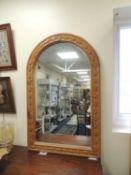 DECORATIVE ARCHED WALL MIRROR with carved bell flower frame, 121 x 77cms Provenance: private