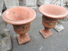 PAIR OF PAINTED RECONSTITUTED STONE GARDEN URNS, finished in terracotta colour, 58cms (h)