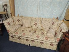 QUALITY KNOLE SETTEE, upholstered throughout in a peacock and foliate patterned fawn ground fabric